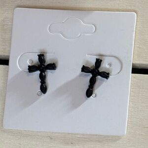 Matte finish black metal cross earrings.